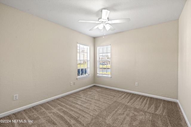 spare room with ceiling fan and carpet floors