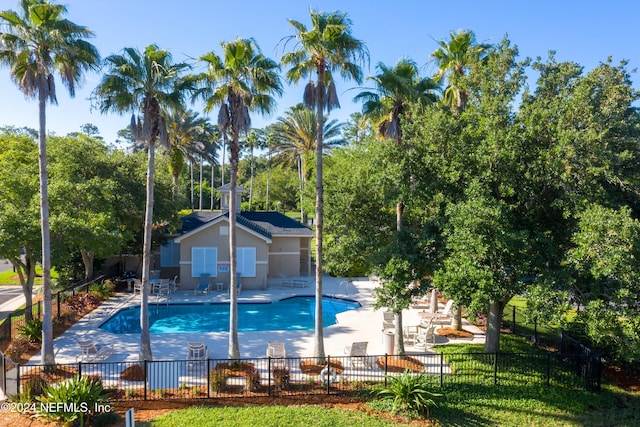 view of pool featuring a yard and a patio