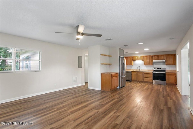 kitchen featuring ceiling fan, sink, dark hardwood / wood-style flooring, a textured ceiling, and appliances with stainless steel finishes