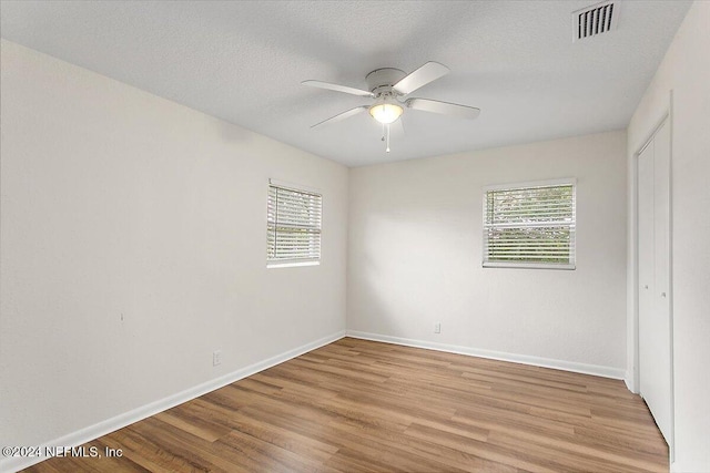 interior space with plenty of natural light, light hardwood / wood-style floors, a textured ceiling, and ceiling fan