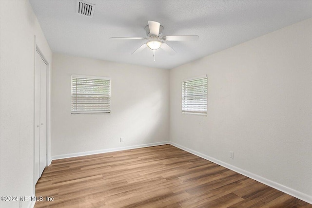 unfurnished room featuring hardwood / wood-style flooring and ceiling fan