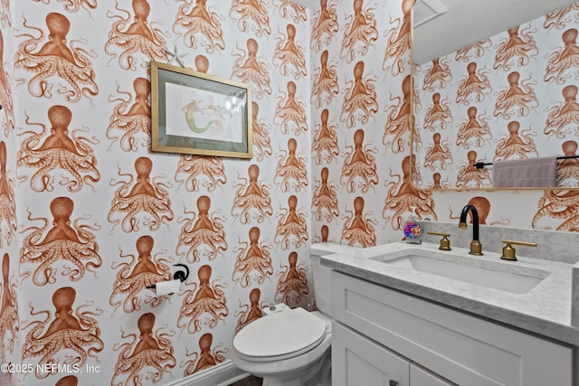 bathroom with vanity, a textured ceiling, and toilet