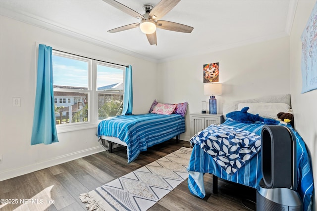 bedroom featuring hardwood / wood-style flooring, ceiling fan, and crown molding