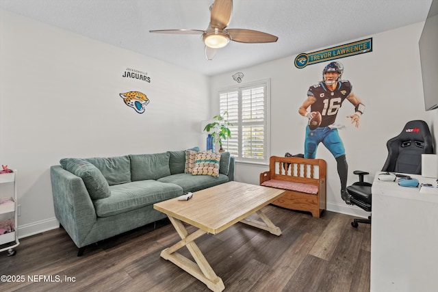 living room featuring ceiling fan, dark hardwood / wood-style flooring, and a textured ceiling