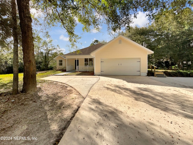 ranch-style home featuring a garage and covered porch