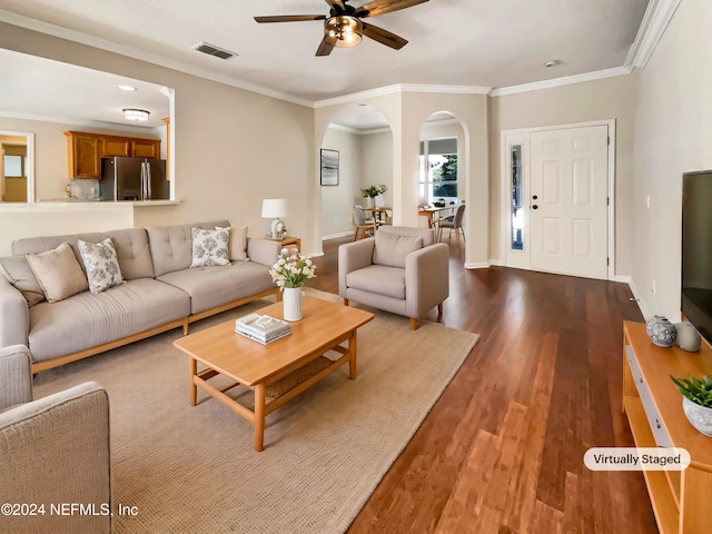 living room featuring light wood-type flooring, ceiling fan, and crown molding