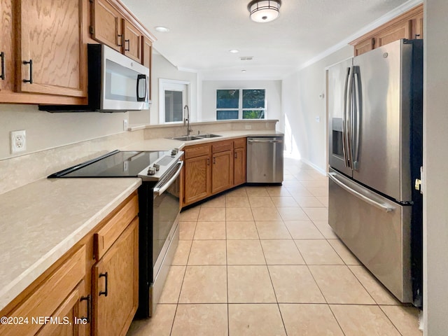 kitchen featuring sink, light tile patterned floors, stainless steel appliances, and ornamental molding