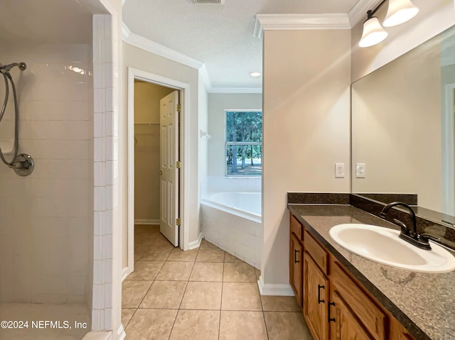 bathroom featuring tile patterned flooring, vanity, crown molding, and independent shower and bath