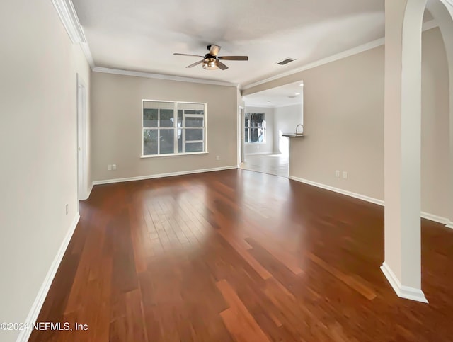 spare room featuring ceiling fan, dark hardwood / wood-style floors, and ornamental molding