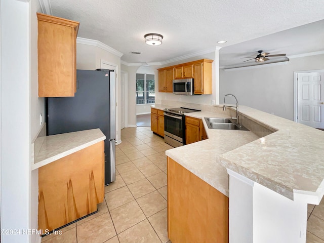 kitchen featuring sink, ceiling fan, ornamental molding, kitchen peninsula, and stainless steel appliances