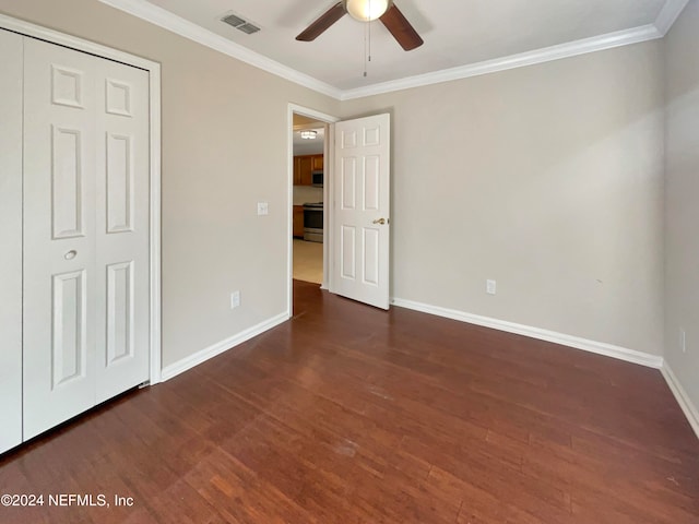 unfurnished bedroom featuring dark hardwood / wood-style floors, ceiling fan, and ornamental molding