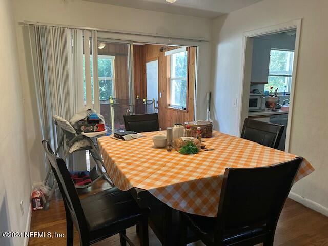 dining area with a healthy amount of sunlight and hardwood / wood-style flooring