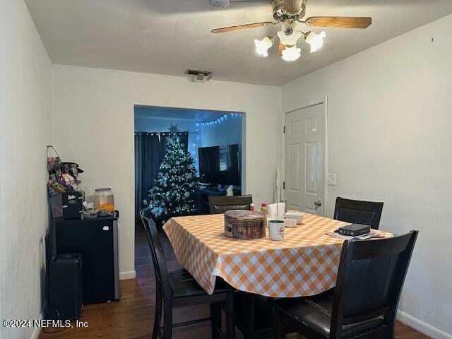 dining space with ceiling fan and dark hardwood / wood-style floors