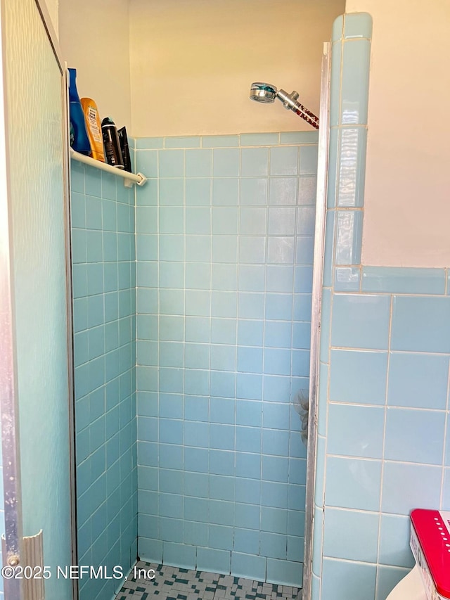 bathroom with a tile shower