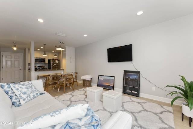 410 1st St S Unit C, Jacksonville Beach, FL 32250 - living area featuring baseboards, light wood finished floors, and recessed lighting