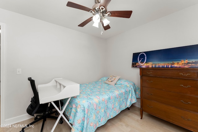 bedroom with light hardwood / wood-style floors and ceiling fan