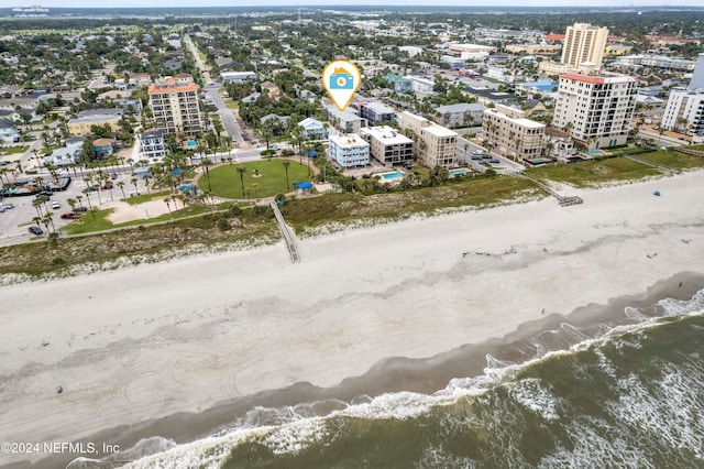 bird's eye view with a water view and a view of the beach