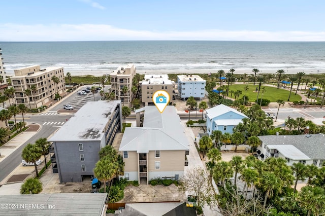 drone / aerial view with a water view and a view of the beach