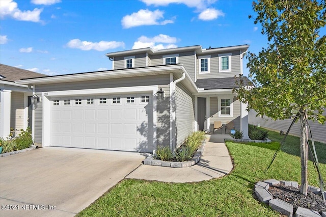 view of front of property with a front lawn and a garage