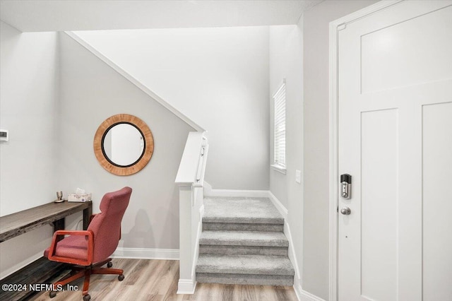 stairway with hardwood / wood-style floors