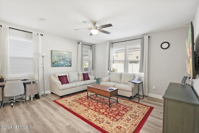 living room featuring hardwood / wood-style floors and ceiling fan