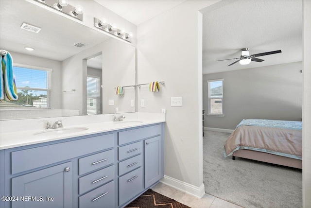 bathroom featuring tile patterned flooring, ceiling fan, a textured ceiling, and vanity