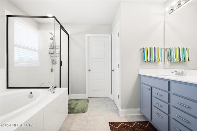 bathroom with tile patterned flooring, shower with separate bathtub, and vanity