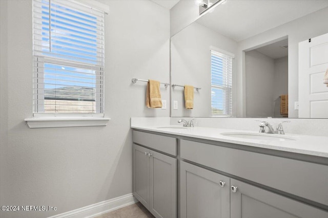 bathroom with tile patterned flooring and vanity