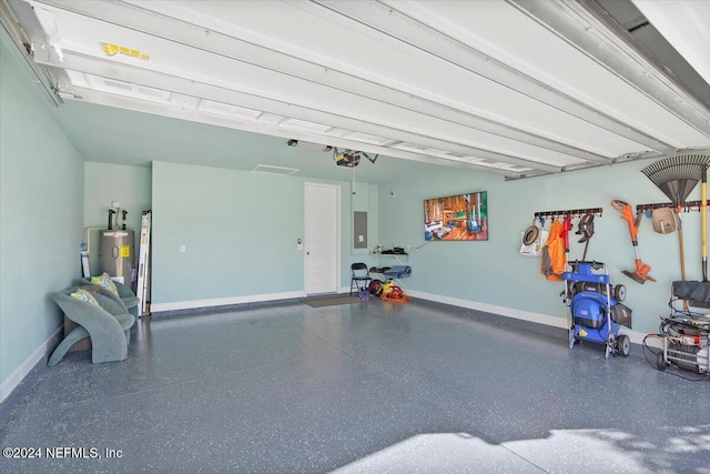 garage featuring electric panel, water heater, and a garage door opener