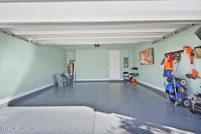 garage with gas water heater, electric panel, and a garage door opener