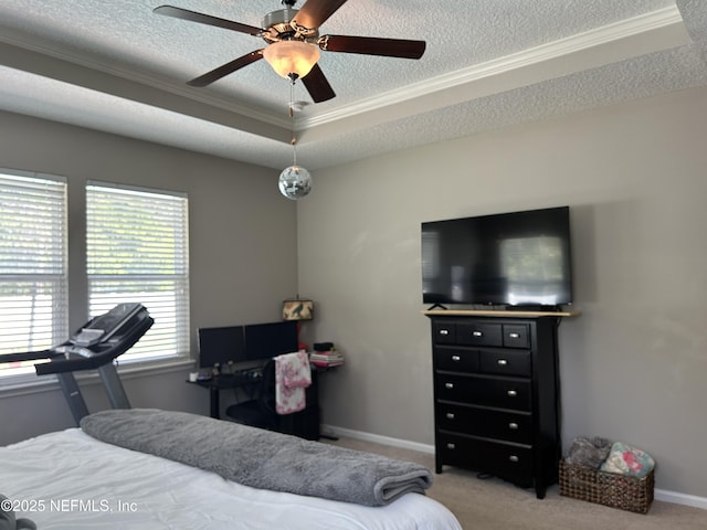 carpeted bedroom with crown molding, baseboards, a raised ceiling, and a textured ceiling