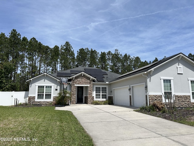 ranch-style house with driveway, stone siding, fence, and an attached garage