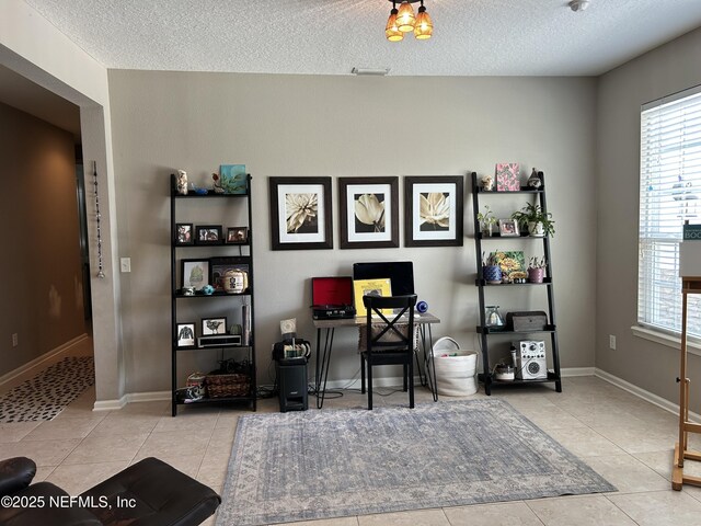 office area featuring tile patterned flooring, a textured ceiling, and baseboards