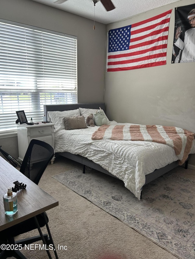 carpeted bedroom featuring a textured ceiling