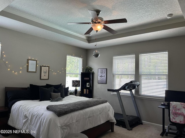 bedroom with a raised ceiling, a textured ceiling, ornamental molding, and carpet floors