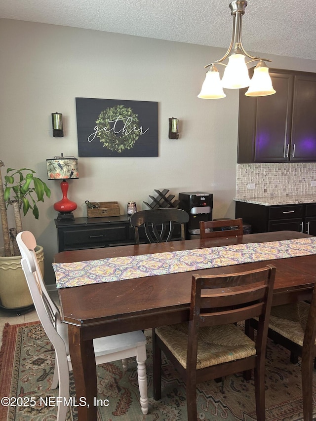 dining area featuring a textured ceiling