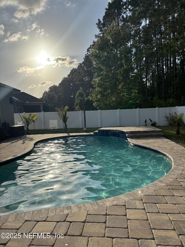 view of swimming pool featuring a fenced backyard, a fenced in pool, and a patio area