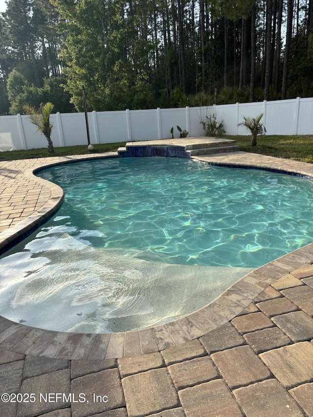 view of swimming pool with a fenced in pool and a fenced backyard