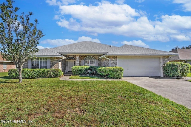 ranch-style house featuring a garage and a front lawn