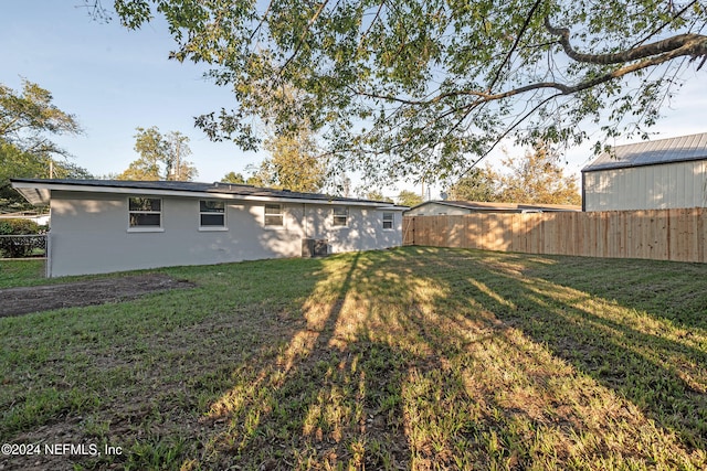 back of property featuring a yard