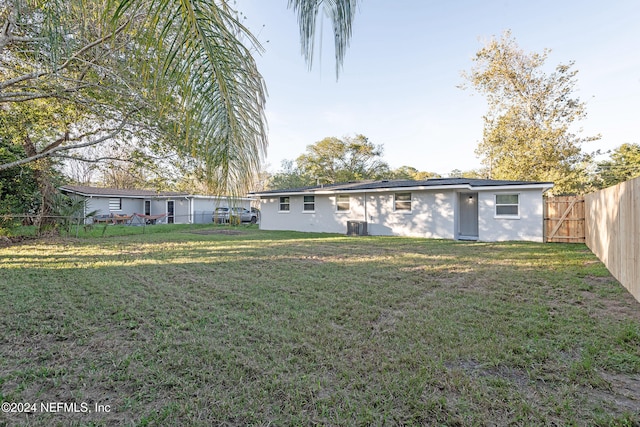 rear view of house featuring a yard