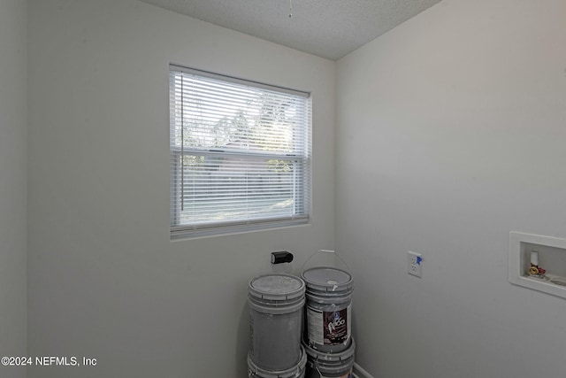 washroom featuring washer hookup and a textured ceiling