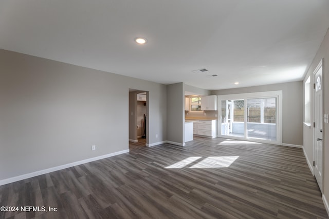 unfurnished living room with dark hardwood / wood-style flooring