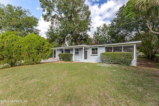 single story home featuring a front lawn and a sunroom