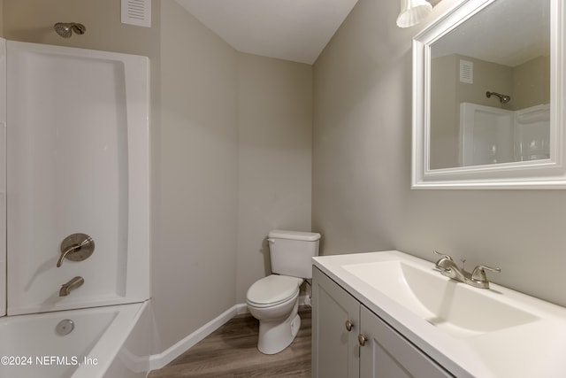 full bathroom with vanity, toilet, wood-type flooring, and bathing tub / shower combination