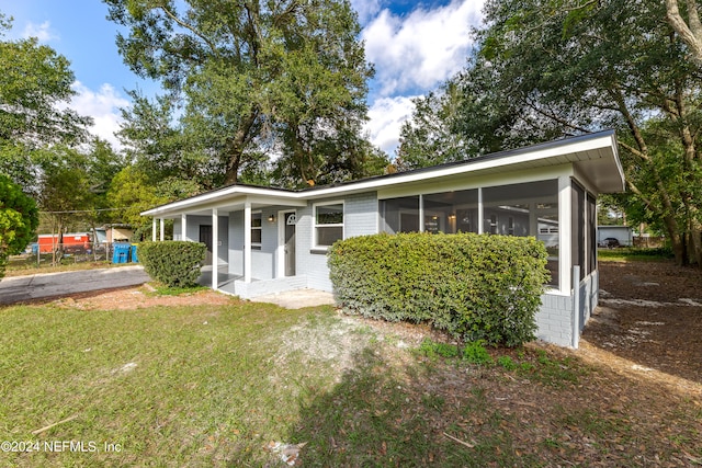 ranch-style home with a porch and a front yard