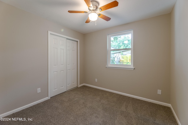 unfurnished bedroom featuring carpet flooring, a closet, and ceiling fan