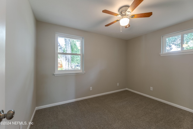 empty room featuring ceiling fan and carpet floors