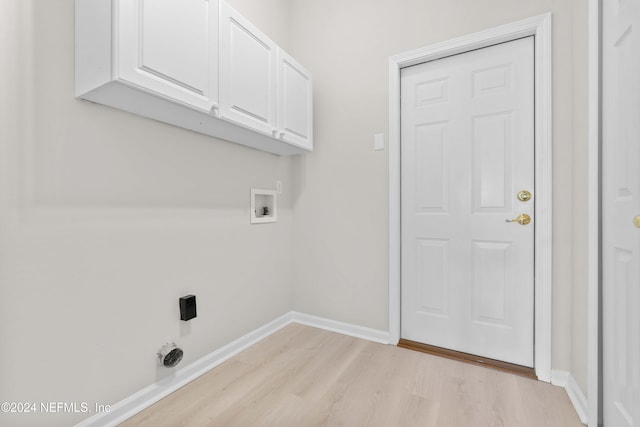 laundry room featuring washer hookup, hookup for an electric dryer, cabinets, and light wood-type flooring