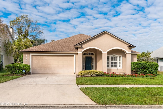 view of front facade with a front yard and a garage